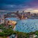 A cityscape of Sydney Harbour with the Sydney Harbour Bridge and sailboats in Sydney, Australia